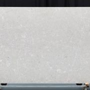 Full slab of Alabaster stone, featuring a warm, light grey base with a delicate and intricate network of soft white veins