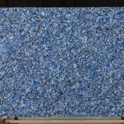 Full slab of ST Bayside stone, featuring a dramatic and chaotic swirling pattern of vibrant blue, black, and white, reminiscent of swirling water