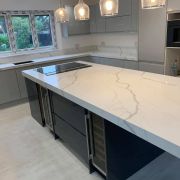 Spacious modern kitchen featuring a large central island, worktops, and upstands in ST Quartz Bianco Calacatta marble-effect quartz