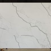 Full slab of ST Quartz Bianco Calacatta, a stunning quartz that replicates Calacatta marble with its thick, branching grey veins on a pure white background