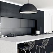 Minimalist kitchen design showcasing a Nile Quartz Bianco Glacier worktop with a waterfall edge, creating a bold contrast with dark wood grain cabinet