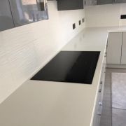 Sleek ST Quartz Blanco White worktop installed in a modern kitchen with a flush-mounted induction hob