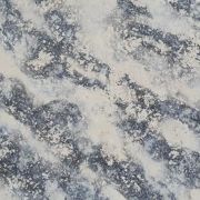 Nile Quartz Cloud Burst slab, showcasing its textured, stormy bursts of dark grey and black erupting across a pale, creamy quartz background
