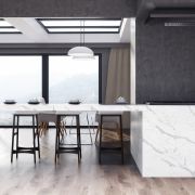 A luxury architectural kitchen design showcasing a Nile Quartz Calacatta Supreme worktop and waterfall end