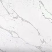 A slab of Nile Quartz Calacatta Supreme, a premium Statuario-style quartz with a dramatic, flowing pattern, perfect for a statement kitchen island