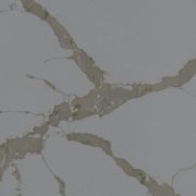 Detailed close-up of ST Quartz Calacatta Vena, showcasing the warm taupe-grey veins and contrasting fine hairline cracks on a cool, light grey base