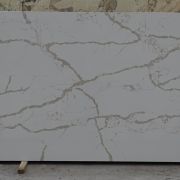 Full slab of ST Quartz Calacatta Vena, a marble-effect quartz featuring a bold network of warm taupe-grey veins on a cool, light grey background