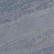 Detailed close-up of ST Quartz Cielo, showcasing the soft, layered bands of tonal blue and off-white veining on the crystalline, slate-blue base