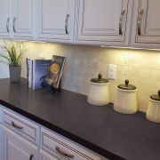 A black sparkle Nile Quartz Nero Starlight worktop fitted with traditional off-white kitchen cabinets