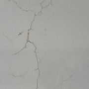 Detailed close-up of ST Quartz Nevada, showcasing a delicate, golden-brown crackle vein on the finely speckled, off-white quartz base