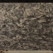 Full slab of ST Quartz Oakham, a dramatic dark quartz featuring a complex, swirling pattern of warm beige on a charcoal grey base, resembling natural granite