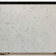 Full slab of ST Quartz New Carrara, a quartz that replicates Carrara marble with its soft, feathery grey veining on a light background.