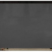 Full slab of ST Quartz Grigio Sparkle, a contemporary dark grey quartz with a uniform scattering of reflective mirror flecks