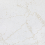 Detailed close-up of ST Quartz Statuario Gold, showcasing the crystalline texture of the warm, golden-beige veins on a creamy white base