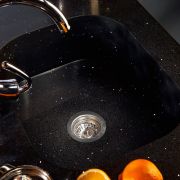 Installation of a black sparkling Silestone Stellar Night worktop featuring a matching, fully integrated Silestone Integrity sink for a flawless finish